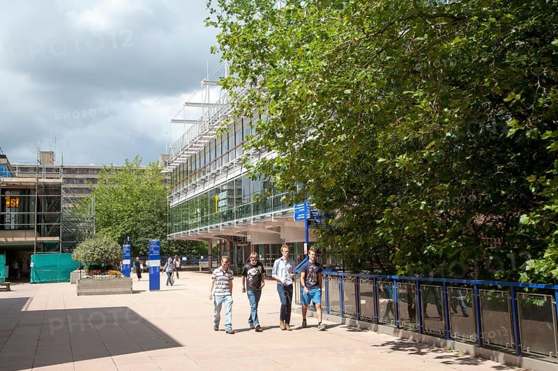 Male students walking on campus near the library building at the University of Bath, England, United Kingdom, Europe