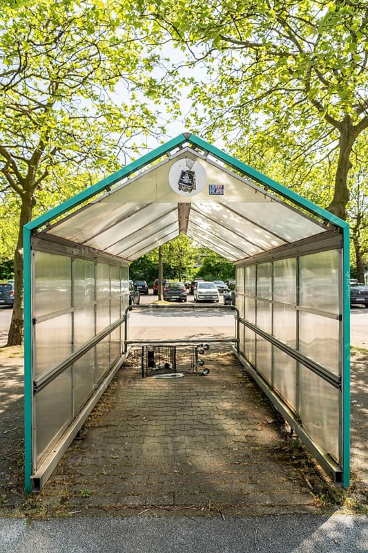 Shelter for shopping trolleys, empty, abandoned in a car park, no longer needed, shop closed