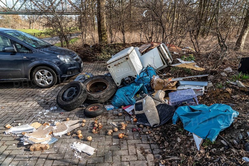 Illegal waste disposal in a car park, in a wooded area, tyres, furniture, refrigerators, household waste, oil cans, Oberhausen North Rhine-Westphalia, Germany, Europe
