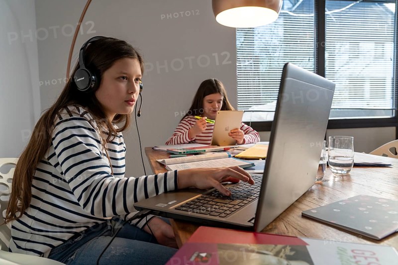 Homeschooling, during the lockdown in January 2021, children learning at home for school, a girl in video lessons, video chat, with here class, a girl learning with a tablet computer, school closures, distance learning, effects of the corona crisis in Germany