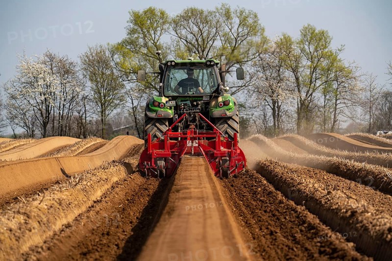 A farmer builds asparagus ridges on a field with the help of an asparagus tiller, in which the asparagus then grows, Dormagen, North Rhine-Westphalia, Germany, Europe