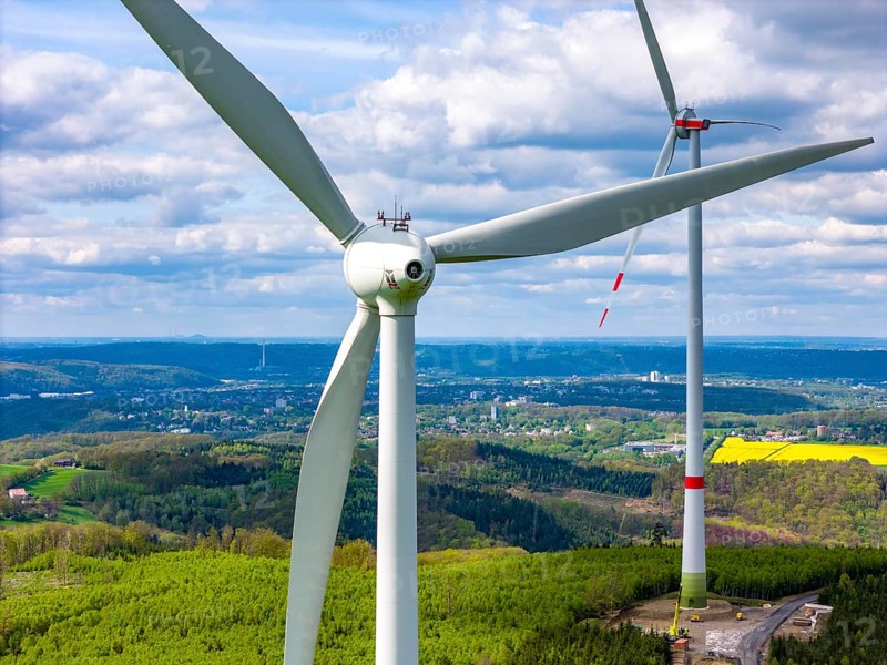 Erection of a wind turbine, wind energy plant, assembly of the ring generator, with a crawler lattice crane, wind farm near Hagen, North Rhine-Westphalia, Germany, Europe