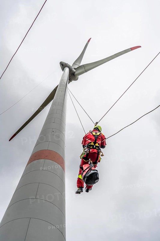 Height rescuers from the Oberhausen fire brigade practise abseiling from a wind turbine from a height of 150 metres after rescuing an accident victim from the nacelle, Issum, North Rhine-Westphalia, Germany, Europe