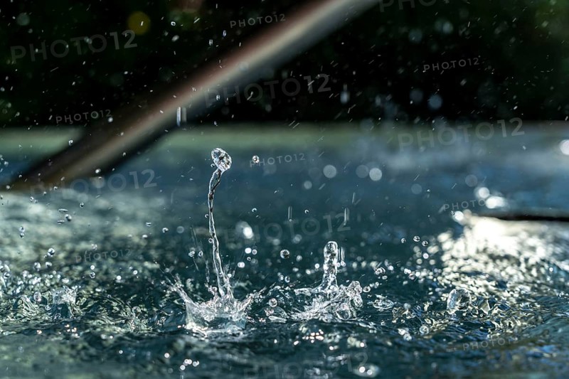 Drops of water hit the water surface