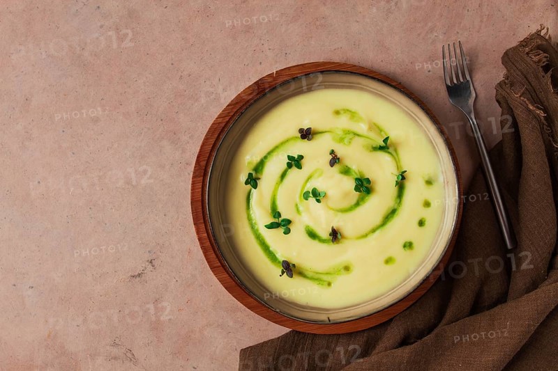 Mashed potatoes, with green butter and micro greenery, homemade, on a beige table, no people, top view