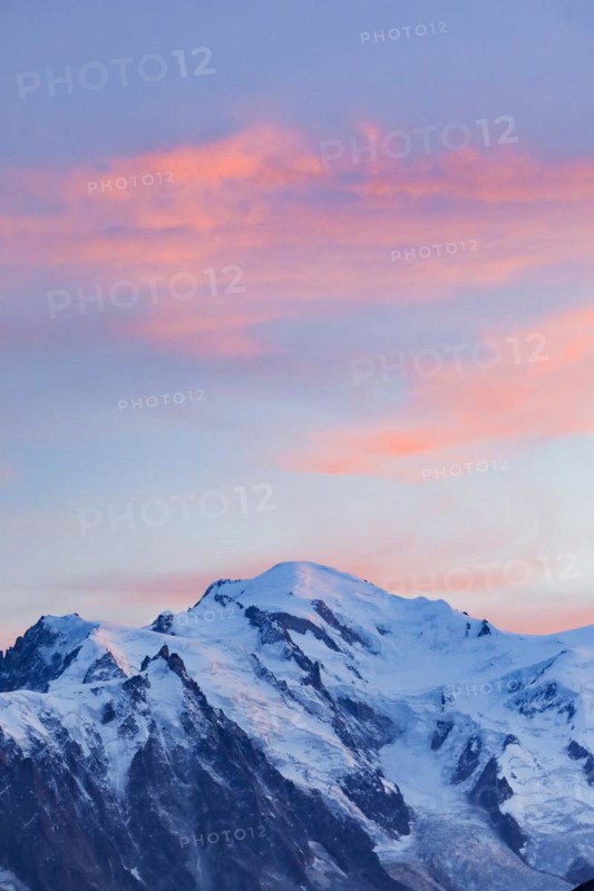 Red-coloured clouds over the summit of Mont Blanc with Aiguille du Midi in the foreground, Savoie, France, Europe