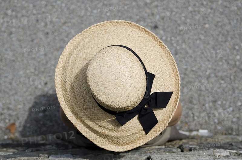 Woman with Straw Hat Leaning on the Wall