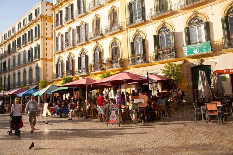 People enjoying a sunny spring afternoon in bars on the Plaza de la Merced, Malaga Spain