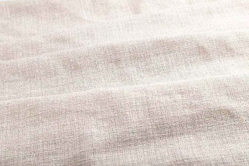Fragment of white linen tissue. Side view, natural textile background and texture. wave concept, abstract