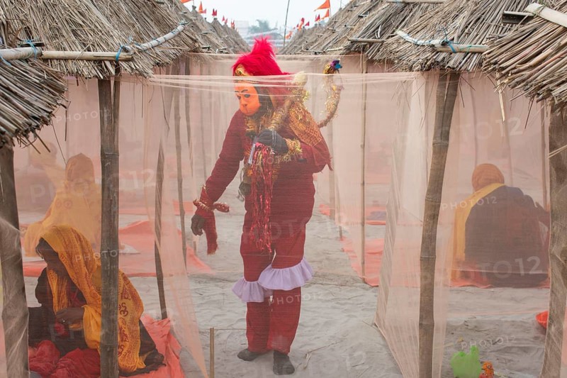 A devotee dressed as Hindu monkey-faced God Hanuman, standing next to camps, on the eve of consecration ceremony of the Ram temple, in Ayodhya, Uttar Pradesh, India on 22 January 2024