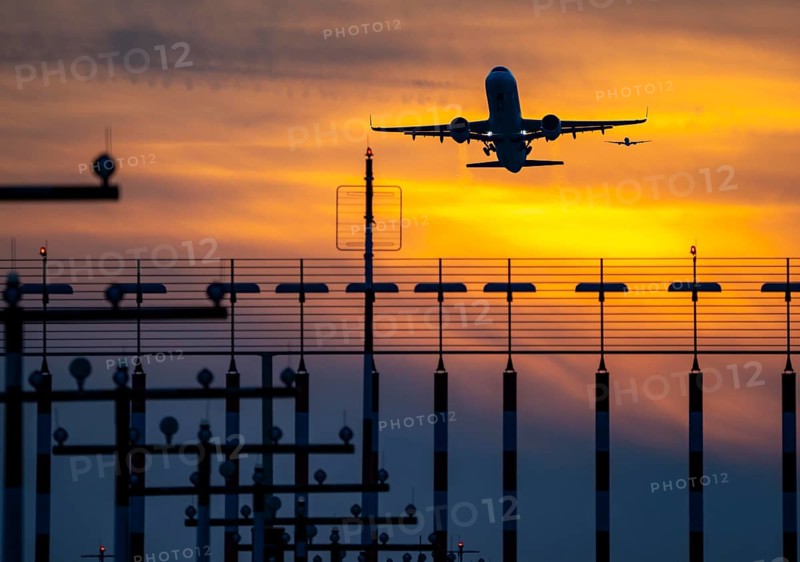 Runway lighting, approach aids, at Düsseldorf International Airport, sunset, aircraft taking off and approaching the southern main runway, 05R/23L, North Rhine-Westphalia, Germany, Europe