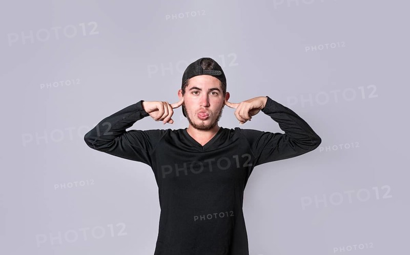 Man covering his ears isolated, guy covering his ears on isolated background, man with hands on his ears and making fun, man ignoring problems