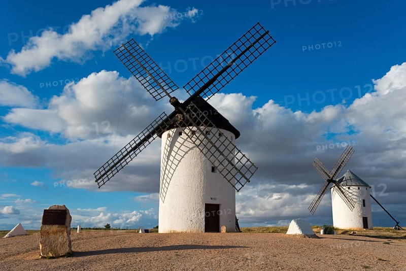 Windmill in a rural setting under a blue sky with dramatic clouds, windmills, Campo de Criptana, Ciudad Real province, Castilla-La Mancha, Don Quixote Route, Spain, Europe