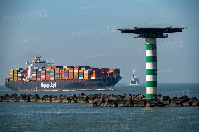 Container freighter Al Manamah, owned by Hapag-Lloyd, in the harbour entrance of the deep-sea port Maasvlakte 2, the seaport of Rotterdam, Netherlands, on an artificial land area off the original coast