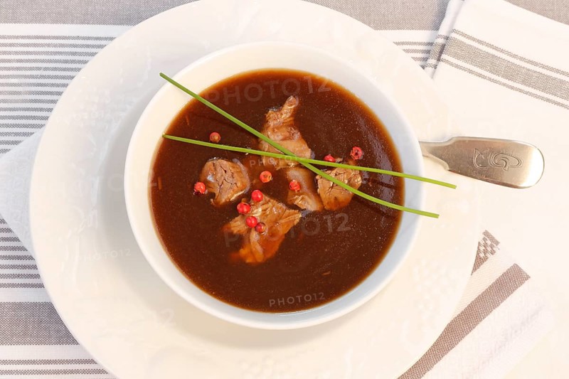 Southern German cuisine, oxtail soup with red pepper in a soup plate, bound soup, meat soup, chives, soup cup, traditional cuisine, speciality, food photography, studio, Germany, Europe