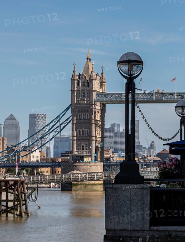 Tower Bridge against a city backdrop and modern skyscrapers, a street lamp in the foreground, London, United Kingdom Great Britain