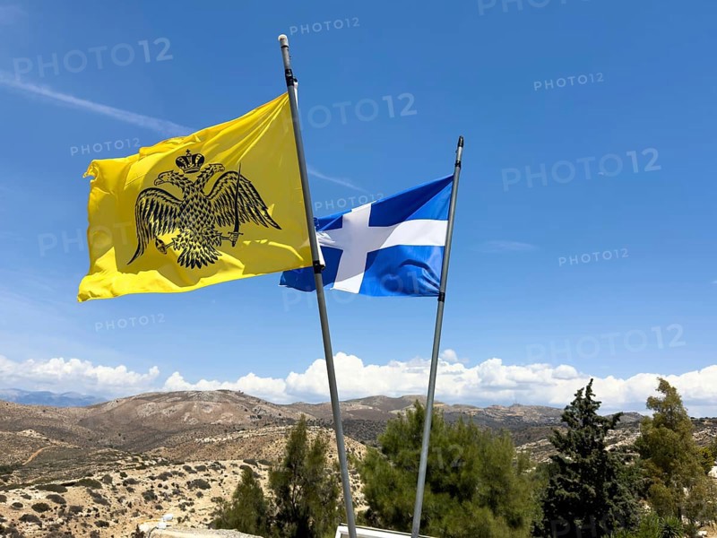 Front mirror-inverted reverse of flag Flag with symbol of Eastern Orthodox Greek Orthodox Church yellow background in black black imperial Byzantine double-headed eagle Byzantine Empire of Palaiologian Dynasty Insignia of Byzantium Crown Sword Orb Globe behind National flag of Crete, Unesco Site Site Orthodox Greek Orthodox Monastery Moni Odigitria, Festos, Crete, Crete