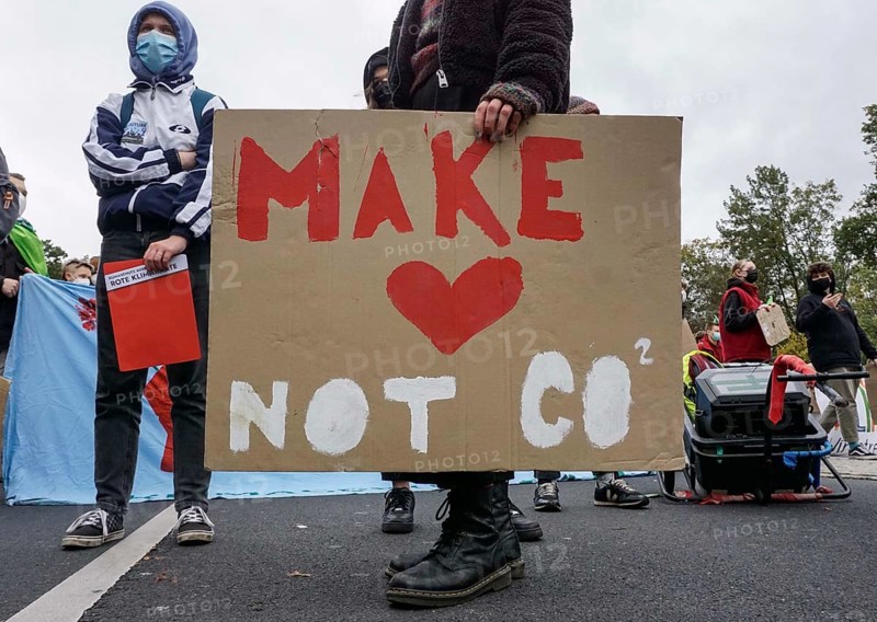 Demonstrator with poster Make Love, Not CO2, climate protection initiative Fridays for Future under the motto You leave us no choice, Berlin, 22 October 2021