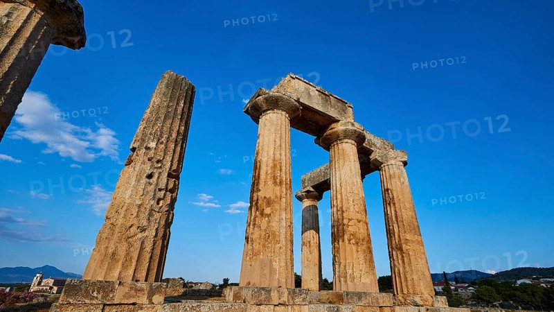 Archaic Temple of Apollo, Doric columns, Historical temple columns with a background of mountain landscape and blue sky, Archaeological site, Archea Korinthos, Corinth, Peloponnese, Greece, Europe