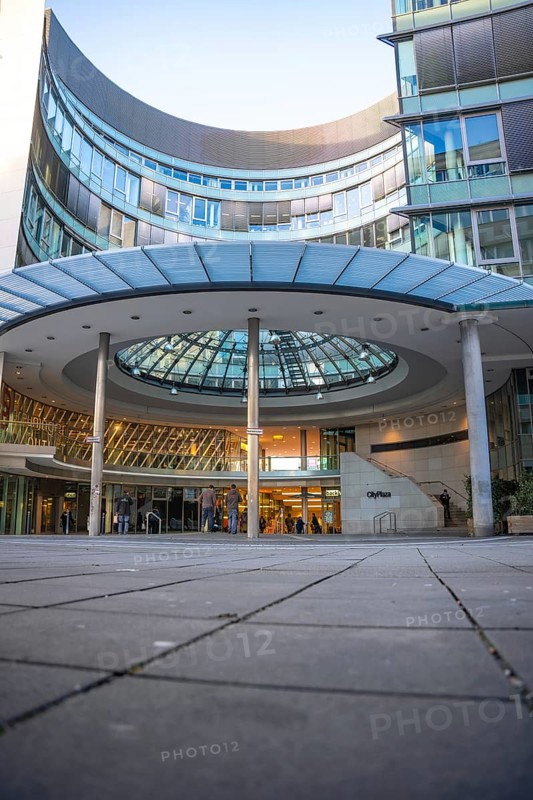 Modern office building with glass façade and curved canopy in the entrance area, City Plaza, Stuttgart, Germany, Europe