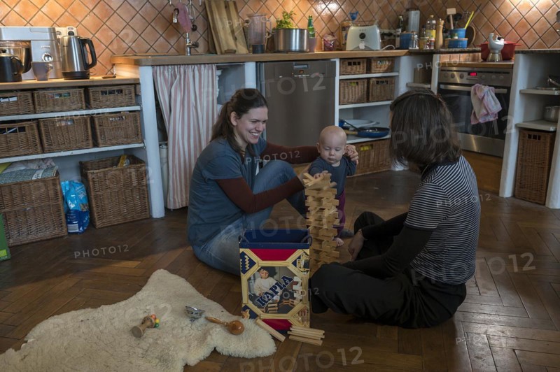 Young mother with her sister and with her son, 8 months, playing on the parquet floor, Mecklenburg-Vorpommern, Germany, Europe