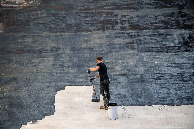 Construction site, application of a bitumen coating to a concrete ceiling, preparation for waterproofing, with bitumen membranes applied thermally, Duisburg, Germany, Europe