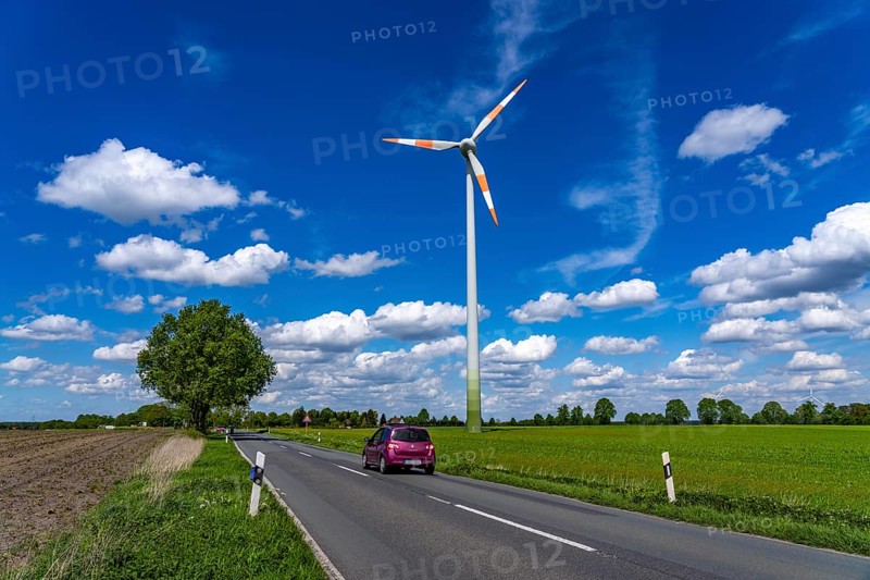 Wind turbine, wind energy plant from the manufacturer Enercon, blue sky with many white clouds, near Schermbeck, country road, Bestener Straße, North Rhine-Westphalia, Germany, Europe