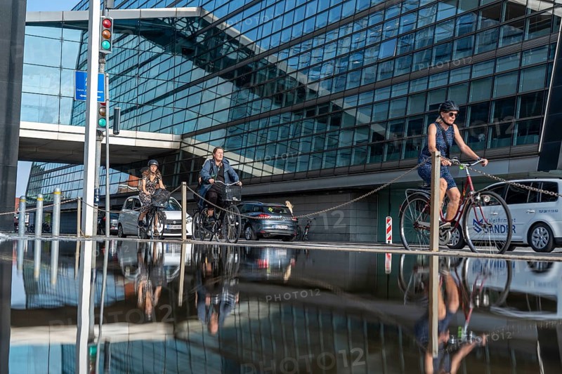 Cyclists on the cycle path on Christians Brygge Street, at the Black Diamond, Danish Royal Library, Copenhagen is considered the cycling capital of the world, 45 % of the population travel by bike, Denmark, Europe
