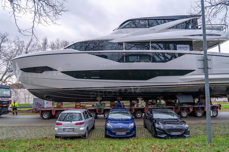 Craning the €6.3 million Sunseeker 88Y motor yacht, weighing 82 tonnes, in preparation for the world's largest water sports trade fair, Boot in Düsseldorf, luxury yachts are driven across the Rhine to the trade fair and brought ashore with the help of the Big Willi ship crane and transported to the exhibition halls on a low-loader, North Rhine-Westphalia, Germany, Europe