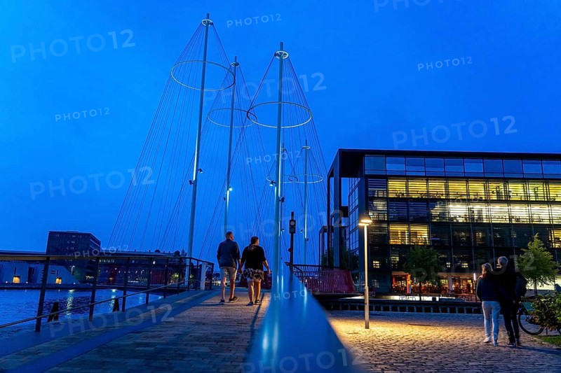 Cyclists on the Cirkelbroen cycle and pedestrian bridge, over the harbour, in the Christianshavens district, Copenhagen is considered the cycling capital of the world, 45 % of the population travel by bike, Denmark, Europe