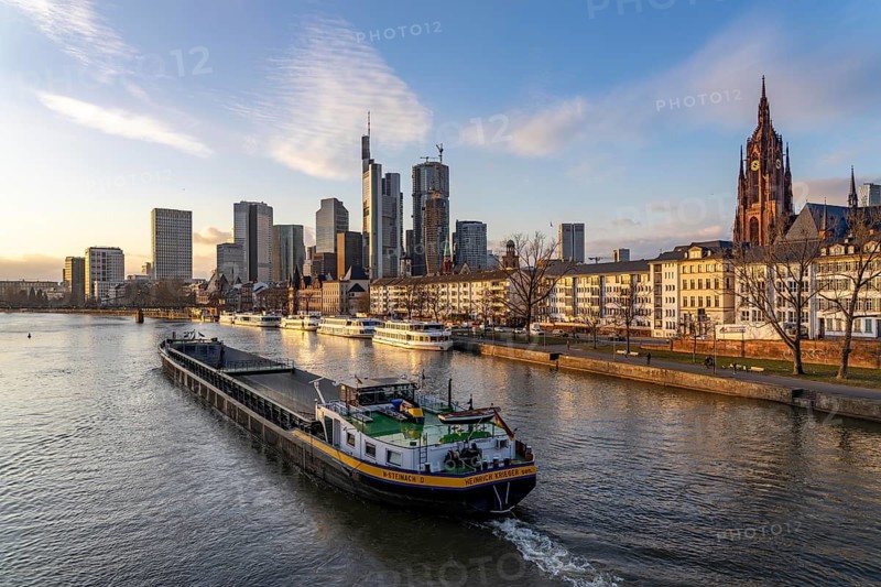 Skyline of the city centre of Frankfurt am Main, river Main, excursion boats at the Main quay, freighter, dusk, Hesse, Germany, Europe