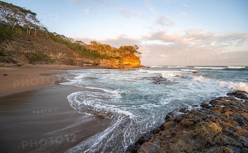 Sandy beach beach with rocks and sea at sunset, Playa Cocalito, coastal landscape, Pacific coast, Nicoya Peninsula, Puntarenas Province, Costa Rica, Central America