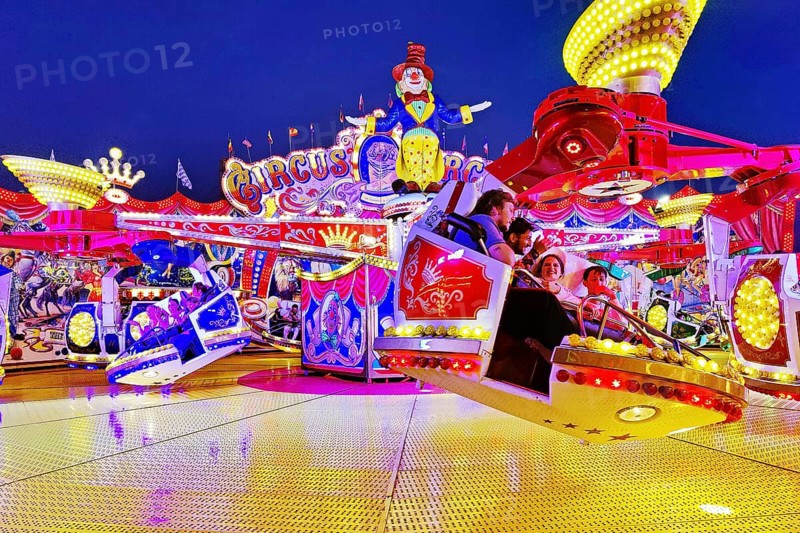 People in the illuminated carousel Circus Circus in the evening, Cranger Kirmes, Herne, Ruhr area, North Rhine-Westphalia, Germany, Europe