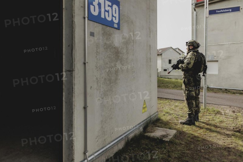 A soldier moves during a simulated house-to-house battle, taken as part of a Bundeswehr exercise with armed forces from Norway and the Czech Republic during the 'Wettiner Schwert' exercise as part of Quadriga 2024 in the training town of Schnöggersburg, 8 April 2024