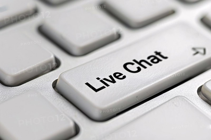 Close up of live chat key on white keyboard. Close up of wind mill turbine covered in ic ein winter, AI generated
