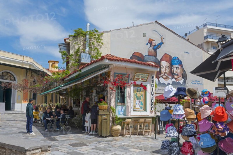 Cosy snack shop under a blue sky on a sunny day, next to it graffiti with 5 heroes of the Greek Revolution of 1821 on the square of 23 March, Kalamata, Messinia, Peloponnese, Greece, Europe
