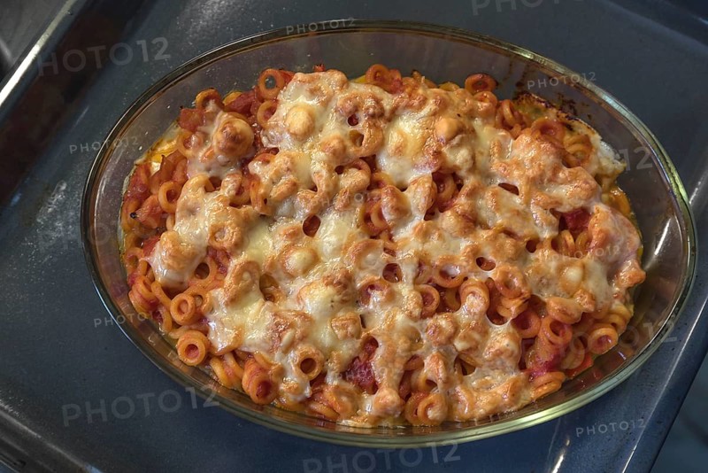 Pasta with tomatoes and cheese baked in a casserole dish in the oven, Franconia, Bavaria, Germany, Europe