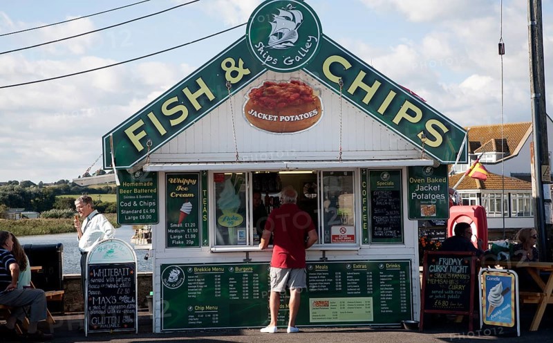 Traditional seaside Fish and Chips small shop booth at West Bay, Bridport, Dorset, England, UK