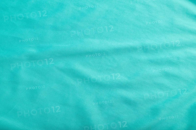 Fragment of smooth silk blue tissue. Top view, flat lay, natural textile background and texture
