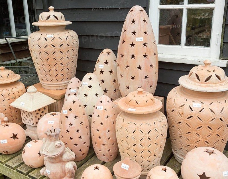 Display of clay lanterns on sale, The Walled garden plant nursery, Benhall, Suffolk, England, UK