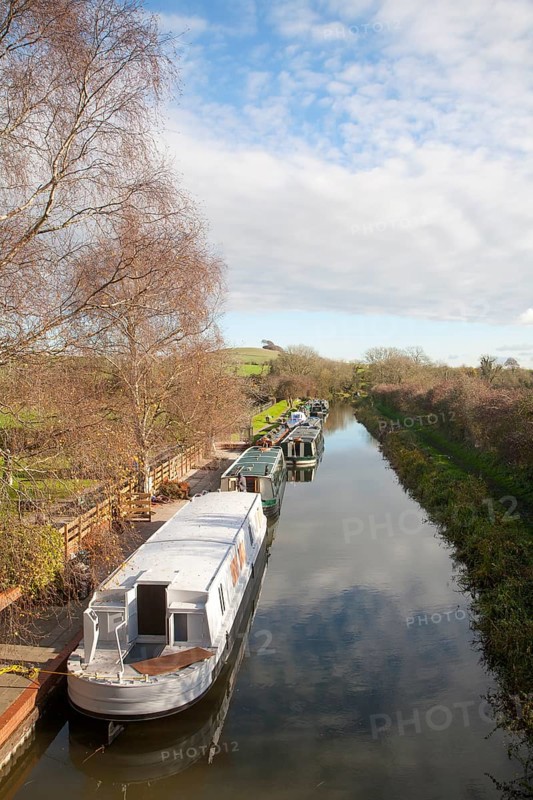 Narrowboats moored on the Kennet and Avon canal at Honey Street, Vale of Pewsey, Wiltshire, England, UK