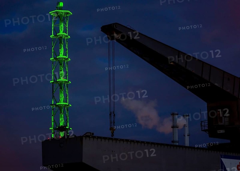 The Stadtwerketurm Duisburg, light installation, decommissioned chimney tower of a former thermal power station, listed building, old harbour crane in the outer harbour, North Rhine-Westphalia, Germany, Europe
