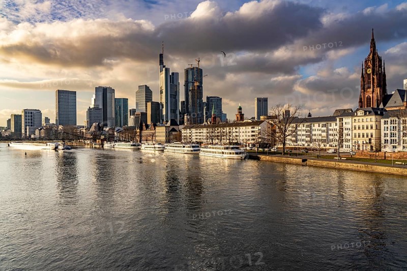 Skyline of the city centre of Frankfurt am Main, river Main, excursion boats at the Main quay, freighter, dusk, Hesse, Germany, Europe