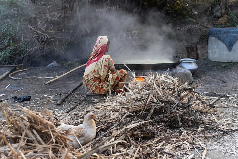 Workers boiling sugarcane juice as they are making Gur (jaggery) in a village on December 10, 2021 in Barpeta, Assam, India. Gur (jaggery) is a natural product of sugarcane, makes from raw, concentrated sugarcane juice, consumed in the Indian Subcontinent and Southeast Asia