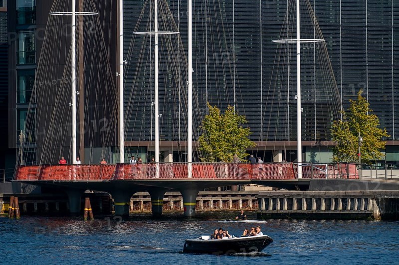 Cyclists on the Cirkelbroen cycle and pedestrian bridge, over the harbour, in the Christianshavens district, Copenhagen is considered the cycling capital of the world, 45 % of the population travel by bike, Denmark, Europe