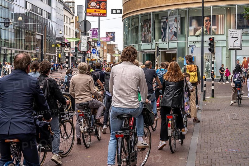 Central cycle path on Lange Viestraat, in the city centre of Utrecht, lanes for pedestrians, cyclists and cars are separated, waiting at traffic lights, heavy traffic, Netherlands