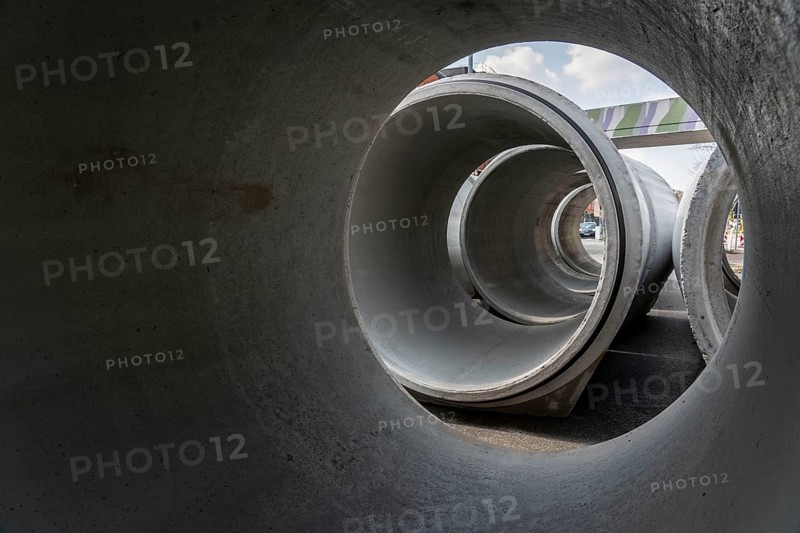 Concrete sewer pipes, stored on a construction site during sewer renovation work, on the Dickswall, city centre of Mülheim an der Ruhr, North Rhine-Westphalia, Germany, Europe