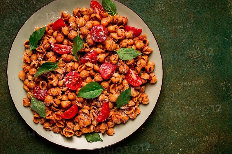 Tuscan pasta with smoked paprika and basil, parmesan cheese, Italian traditional cuisine