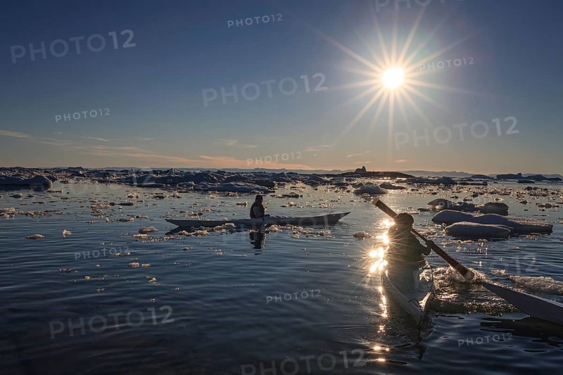 Inuit children paddling kayaks between icebergs, sunny, summer, Ilulissat, Ilulissat Icefjord, Disko Bay, West Greenland, Greenland, North America
