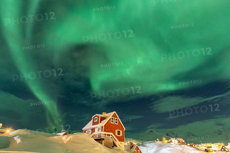 Northern Lights, Aurora borealis over red house, Inuit settlement, Winter, Tasiilaq, East Greenland, Greenland, North America